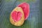 Two halves pink guava with carved heart