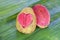 Two halves pink guava with carved heart