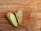 Two halves of potatoes cut on a wooden cutting board