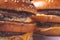 Two Hamburgers, details of two gourmet double burgers, on wooden background, selective focus. tinted image