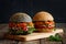 Two hamburgers with fresh vegetables tomato, bell pepper, spicy carrots, parsley and ham, dark and light, on a wooden cutting