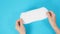 Two hand is holding Sanitary napkin on blue background