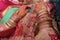 Two hand of indian bride with henna mehndi and pink dress