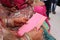 Two hand of indian bride with henna mehndi and pink dress and envelope with gift