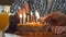 Two hand lighting candles in birthday cake