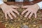 Two hands on the coins scattered on the table