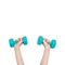 Two hands hold blue dumbbells weighing 1 kilogram each. Sport at home concept. Hand and dumbbells isolated on white