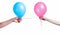 Two hands holding pink and blue balloons