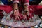 Two hands of indian bride with henna mehndi and bangles and red wedding dress