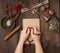 Two hands in a prayer pose on a wooden brown table in the middle of vintage Tibetan meditation tools