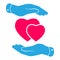 Two hands protecting pink hearts icon