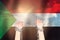 Two hands shackled a metal chain on the background of the Sudan flag. Freedom concept