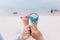 Two hands young teen women holding ice cream cone on summer in beach and sea.