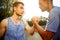 Two handsome athlete men handshake outdoors