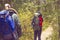 Two handsome, bearded men with backpacks hiking in autumn forest. Camp, adventure, traveling and trip concept.