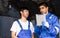 Two handsome male mechanics wearing uniform, using tablet, checking or inspecting for fix, repair car or automobile components,