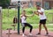 Two handsome young athletes are exercising on the street gym.