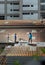 Two handyman workers repairing tiles on the damaged factory roof