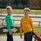 Two happy adorable boys, double portrait, boards hold in hand an