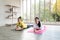 Two happy asian women in yoga poses in yoga studio with natural light setting scene / exercise concept / yoga practice / copy