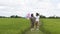 Two happy Asian young girl holding balloon walking at beautiful field rice, Nature background