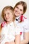 Two happy beautiful young woman and little girl wearing white blouses