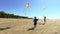 Two happy boys running with kites on the beach