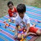 Two happy boys in society park, happy Asian brothers who are smiling happily together. Brothers play outdoors in summer, best