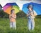 Two happy brother with umbrella summer outdoors