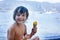 Two happy children, boy brothers, eating ice cream on the beach