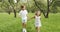 Two happy children boy and girl running on the grass in the garden. Vacation, summer and adventure concept