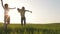 Two happy children playing in the field at the sunset time.