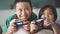 Two happy children are playing game console