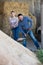 Two happy farm workers holding big shovels