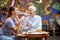 Two happy female friends of different generations having a good time while they have a drink in the bar. Leisure, bar, friendship