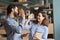 Two happy friendly diverse professionals giving high five standing in office.