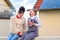 Two happy girls feeling cold outdoor in the city. Young teenagers with reusable bottle and cup on a roof.