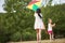 Two happy girls flying a kite