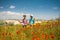 Two happy girls in poppy field outdoor