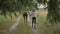 Two happy girls sisters walking after the rain in dirty clothes holding hands