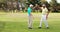 Two happy golf players giving high five