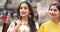 Two happy Indian women at street market