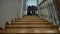 Two happy kids, boy and girl rising up the stairs with their backpacks. Siblings just back home from school. Happy