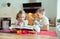 Two happy little and cute children preparing muffins in modern k