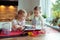 Two happy little and cute children preparing muffins in modern k