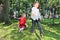 Two happy little girls catch soap bubbles among trees