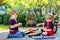 Two happy little kid boys repair chain on bikes and change wheel of balance bicycle