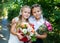Two happy little schoolgirls with bouquets