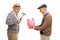 Two happy mature men preparing to break a piggybank with a hammer