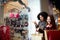 Two happy multiethnic young mixed race woman shopping for lingerie near clothing boutique shop window, decide whether to